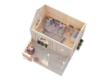 Load image into Gallery viewer, Top-down view of the DIY Playhouse Kit Little Cottage showing the furnished interior with pillows and rug, and a spacious front terrace with flower by WholeWoodPlayhouses