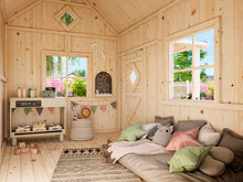 Load image into Gallery viewer, Interior view of the DIY Playhouse Kit Little Cottage, featuring cozy floor cushions, a small chalkboard, decorative bunting, and open windows letting in natural light by WholeWoodPlayhouses