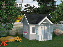 Load image into Gallery viewer, DIY playhouse Little Residence, view from left, in back yard, surrounded by big green trees and next to a sandbox, light grey walls, big windows and flower box under side window, dark tiled roof. White door, wall and window sills and shutters. By WholeWoodPlayhouses.