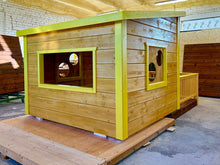 Load image into Gallery viewer, Wooden playhouse with yellow trim on a pallet indoors