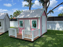 Load image into Gallery viewer, Pink Outdoor  Fully Finished Playhouse Unicorn with white roof, wooden terrace with white railing  on green lawn by WholeWoodPlayhouses