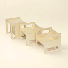 Load image into Gallery viewer, Set of three wooden stools on a beige background