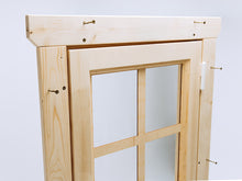 Load image into Gallery viewer, Close-up of wooden playhouse door frame with glass pane and visible assembly screws