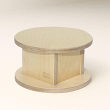 Load image into Gallery viewer, Round wooden platform stool with a visible brand logo on a white background