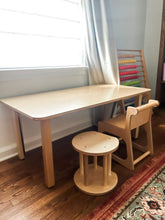 Load image into Gallery viewer, Wooden children's table and chairs in a room with a window and white curtain.