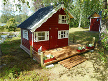Load image into Gallery viewer, Red Wooden Kids Playhouse DIY Kit Little Clubhouse with white window shutters near the lake by WholeWoodPlayhouses