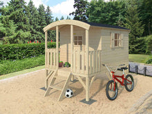 Load image into Gallery viewer, Kids Playhouse DIY Kit Little Bungalow on a playground with a bike next to it by WholeWoodPlayhouses