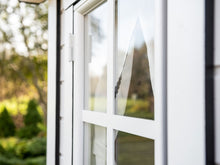 Load image into Gallery viewer, Close up of the front window with curtains of Kids Playhouse Arctic  Nario Outdoor Playhouse by WholeWoodPlayhouses