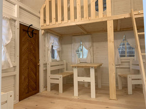 Inside View Of Kids Playhouse Grand Farmhouse, White Walls, Windows With White Curtains, Natural Wooden Color Loft With Ladder And Railing, Kids Furniture by WholeWoodPlayhouses