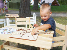 Load image into Gallery viewer, Boy playing on the kids furniture of the Wooden Playhouse Natural Wonder by WholeWoodPlayhouses