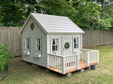 Load image into Gallery viewer, White Outdoor Kids Playhouse Snowy Owl With White Metal Roof, Brown Color Wooden Terrace and White Wooden Railing on Green Lawn Next To Gray Fence by WholeWoodPlayhouses