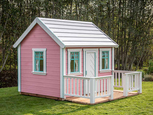 Pink Wooden Playhouse Unicorn with white door on green lawn in a backyard by WholeWoodPlayhouses