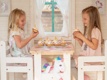 Load image into Gallery viewer, Kids eating inside of Kids Outdoor Playhouse Unicorn with open windows and curtains by WholeWoodPlayhouses