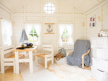 Load image into Gallery viewer, Inside view of Kids Outdoor Playhouse Bluebird with kids furniture, white boxes and marine theme decorations by WholeWoodPlayhouses