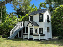 Load image into Gallery viewer, 2- story white Wooden Playhouse Prince with black metal roof, black window trims and flower boxes in the backyard by WholeWoodPlayhouses