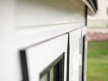 Load image into Gallery viewer, Close up of the white and black Window trim of Kids Outdoor Playhouse Arctic Auk by WholeWoodPlayhouses
