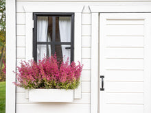Load image into Gallery viewer, Close up of front door, safety glass window with curtains and flower box of Kids Playhouse Arctic Auk by WholeWoodPlayhouses