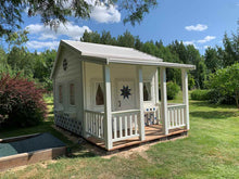 Load image into Gallery viewer, White and blue Kids Playhouse Countryside with the round top window and covered porch in a backyard by WholeWoodPlayhouses