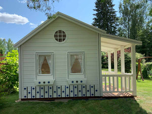 Close up of the left side windows and the round top window of White and blue Kids Playhouse Countryside by WholeWoodPlayhouses