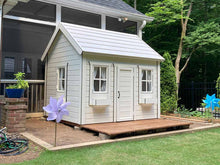 Load image into Gallery viewer, Wooden Playhouse Arctic Nario with white metal roof and white flower boxes with black trims in a backyard by WholeWoodPlayhouses
