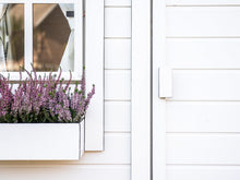 Load image into Gallery viewer, Black and White Wooden Playhouse Close up of front window with flower box and the front door by WholeWoodPlayhouses
