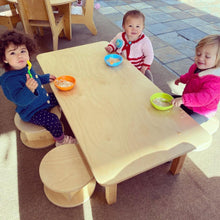 Load image into Gallery viewer, Three children sitting around a small wooden table eating from bowls.
