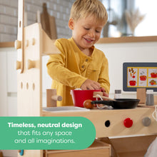 Load image into Gallery viewer, Child playing with a wooden play kitchen set in a neutral-colored room.
