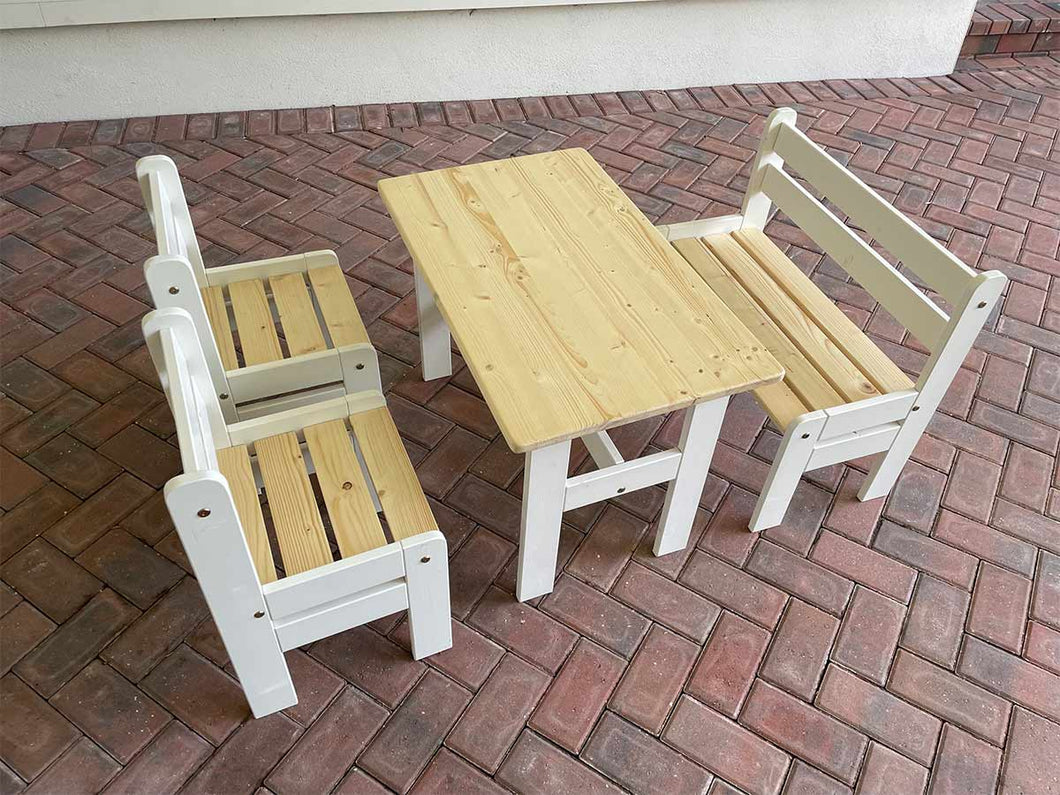 A kids' wooden play furniture set including a table and two chairs with a natural wood finish and white accents on the furniture legs by WholeWoodplayhouses