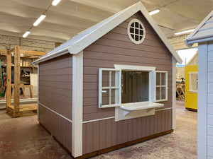 Wooden playhouse with interactive shop window and fold-down counter for pretend storefront play.
