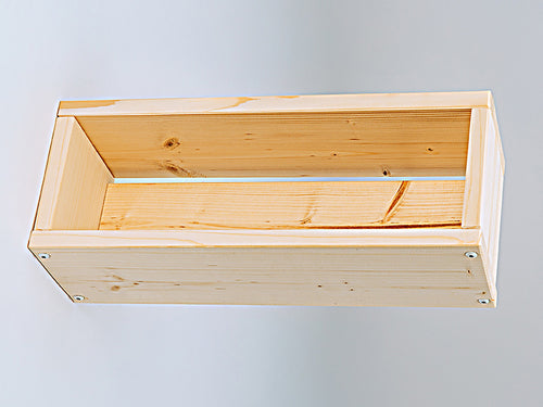 Wooden unfinished flower box on a light gray background