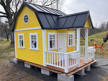 Load image into Gallery viewer, Yellow playhouse with a black roof and white windows  in an outdoor setting
