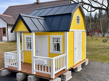 Load image into Gallery viewer, Yellow playhouse with a black roof and white windows in an outdoor setting
