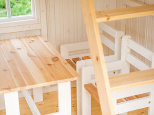Wooden table and chairs in a room with a window by WholeWoodPlayhouses