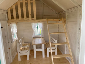 Inside view of Kids Fully Finished Playhouse Unicorn with cozy Loft and Furniture |one bench, two chairs and a table in kids size by WholeWoodPlayhouses