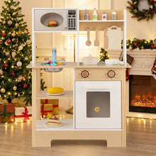 Load image into Gallery viewer, Children's play kitchen set with microwave and oven in a festive room with Christmas tree and fireplace.
