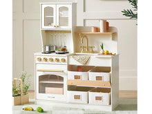 Load image into Gallery viewer, Children's play kitchen set with white cabinets, wooden shelves, and gold accents on a light wooden floor.
