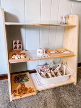 Load image into Gallery viewer, Wooden shelf with various items including a mug, plants, and decorative objects against a light blue wall.
