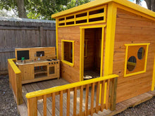 Load image into Gallery viewer, Close-up of the circular window on the Playhouse Chickadee 8x8, highlighting the unique design details and natural wood craftsmanship by WholeWoodPlayhouses
