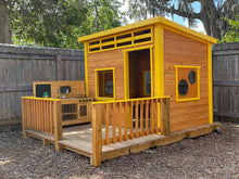 Load image into Gallery viewer, Playhouse Chickadee 8x8 with an outdoor play kitchen setup, featuring a natural wood structure with bright yellow accents and a front terrace by WholeWoodPlayhouses
