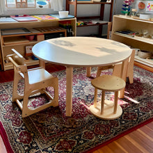 Load image into Gallery viewer, Children's wooden table and chairs on a patterned rug in a classroom setting.
