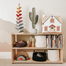 Load image into Gallery viewer, Wooden shelf with toys, books, and decorative items against a plain wall.
