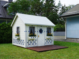 White and blue Kids Playhouse Cornflower on green lawn in a backyard by WholeWoodPlayhouses