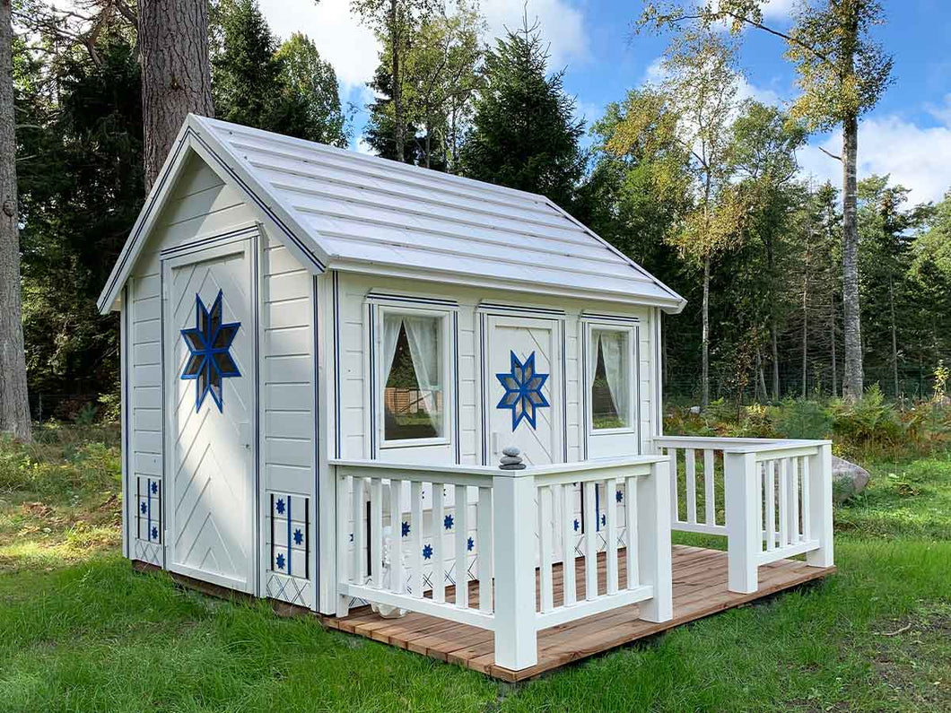 White and blue Kids Playhouse Cornflower on green lawn by WholeWoodPlayhouses