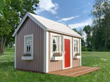 Load image into Gallery viewer, Kids OutDoor Playhouse Plum With Terrace On Gras. Beige Walls, Red Door, And White Flower Boxes. View Form Left Side, In A Backyard By WholeWoodPlayhouses
