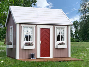 Kids Playhouse Plum with  red door, flower boxes and terrace in a backyard by WholeWoodPlayhouses 