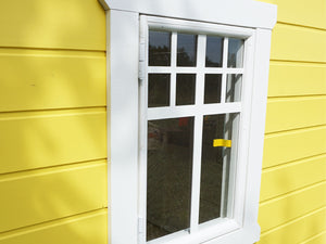 Close up of the window of Kids playhouse Sunny Sadie | yellow Outdoor Playhouse with white opening window by WholeWoodPlayhouses