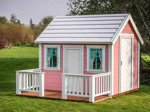 Pink Outdoor Playhouse Unicorn with white roof, wooden terrace and white wooden fence on green lawn by WholeWoodPlayhouses