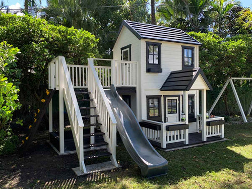 2- story Wooden Playhouse Prince with gray slide, climbing wall, wooden terrace and flower boxes by WholeWoodPlayhouses