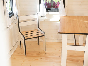 Inside of a Wooden Playhouse Blackbird with kids furniture set table and chair by WholeWoodPlayhouses