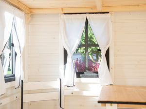 Inside of Outdoor Playhouse Blackbird close up of opening safety glass window with curtains by WholeWoodPlayhouses
